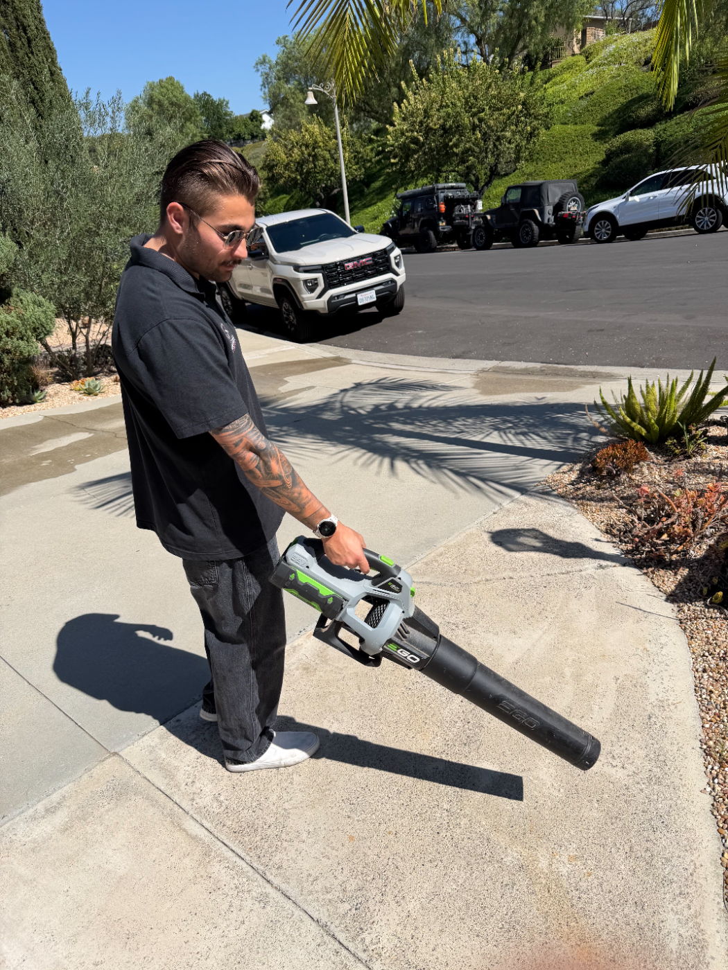 Dylan clearing debris with a leaf blower