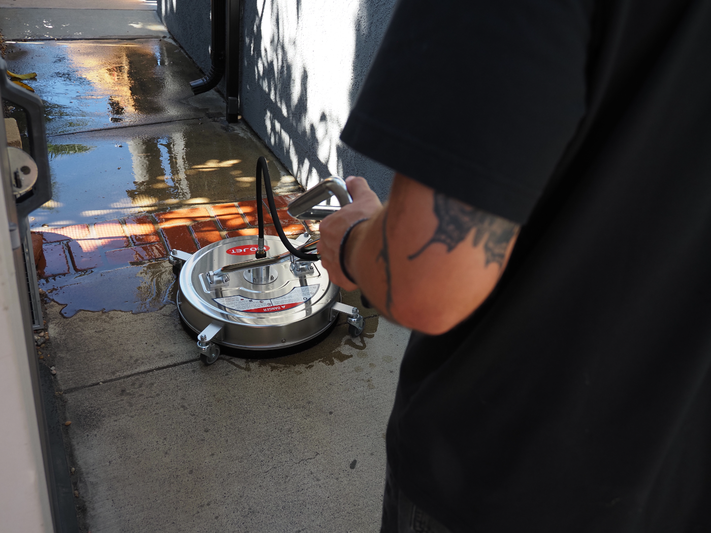 Close-up of the surface cleaner on wet concrete